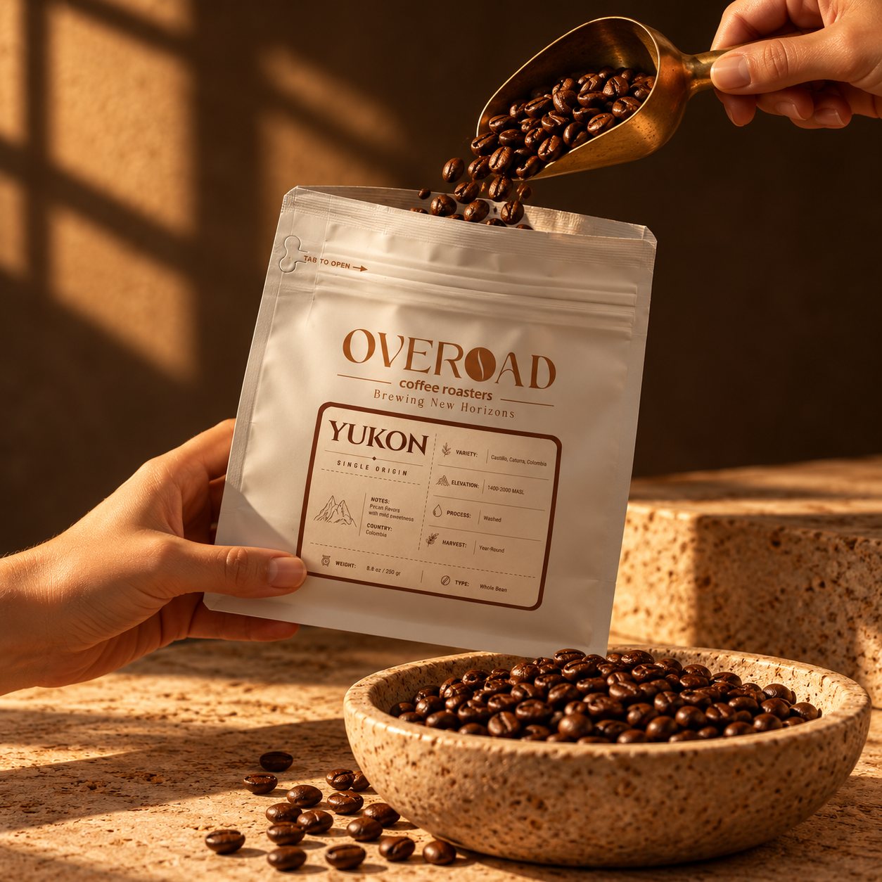 Fresh beans poured from a brass scoop into a YUKON bag